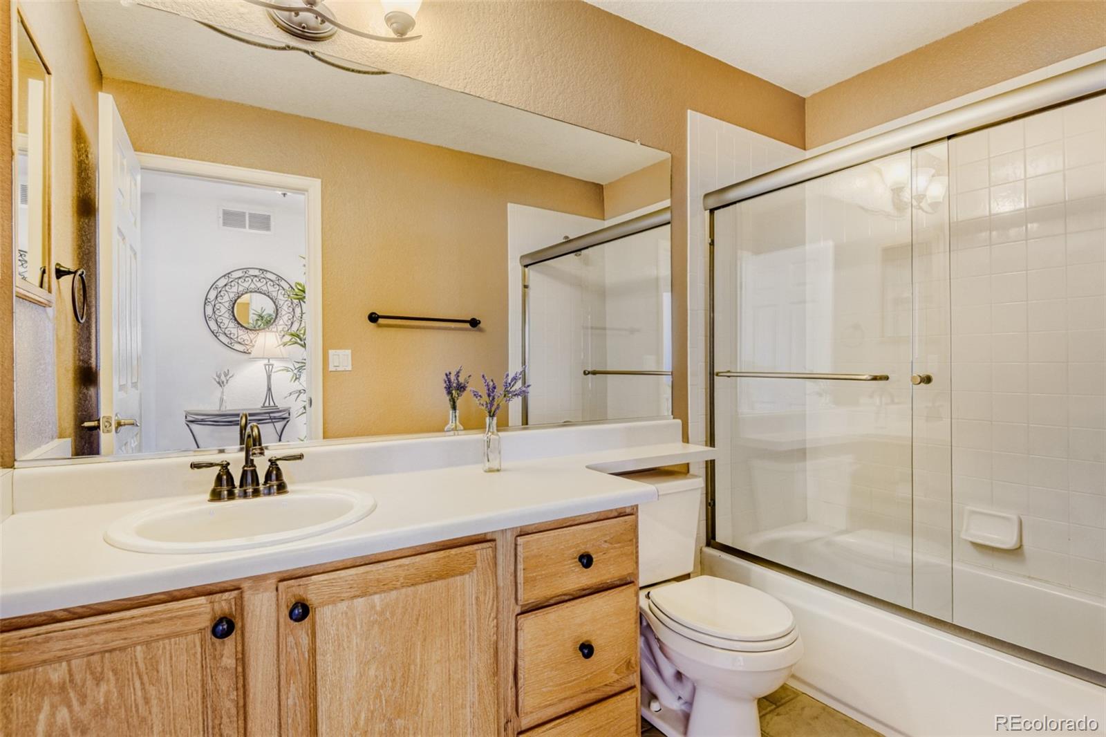 9649 Adelaide Circle Highlands Ranch, CO 80130 - Photo 23 of 32 a bathroom with a sink toilet and shower