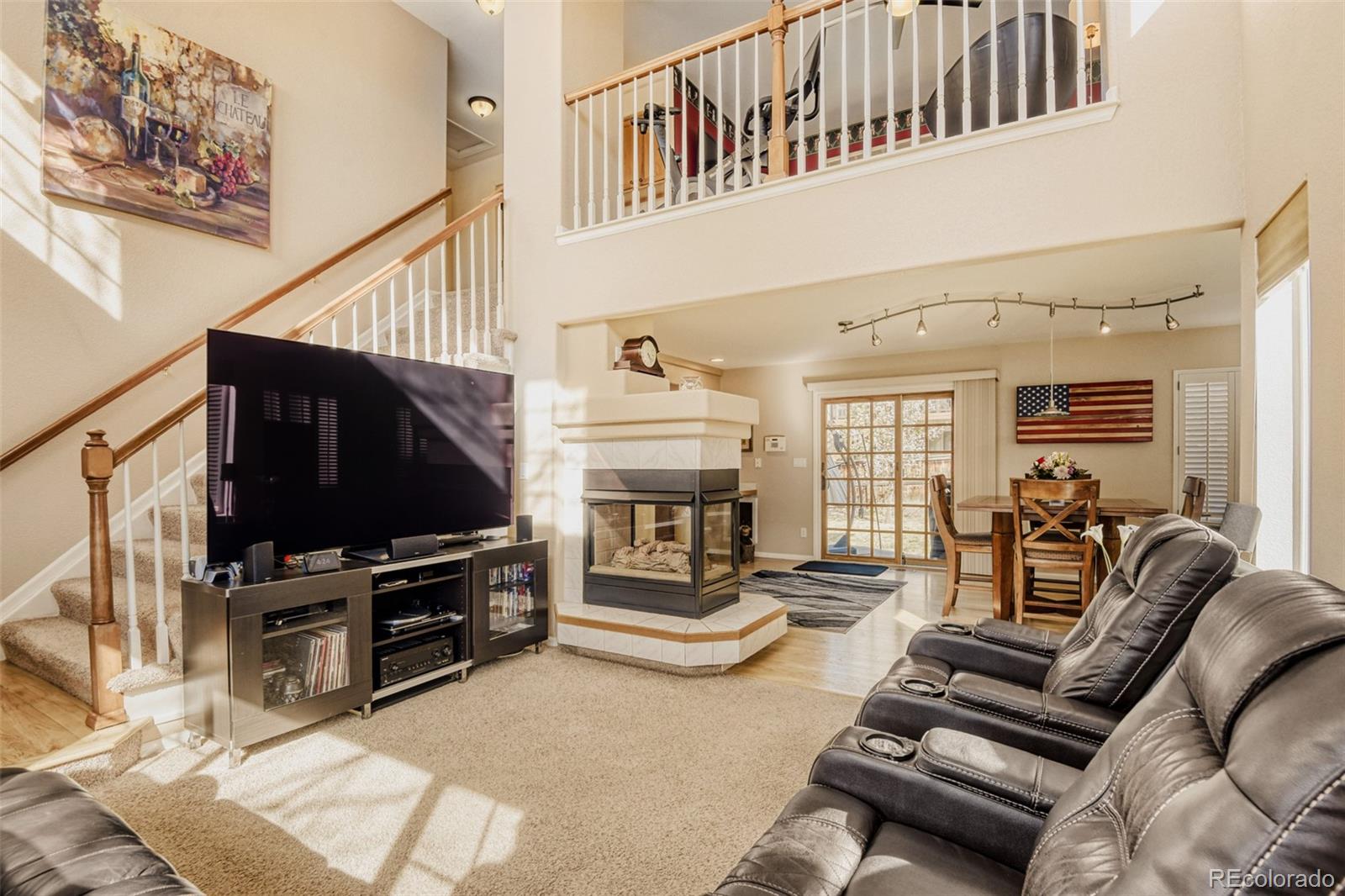 9649 Adelaide Circle Highlands Ranch, CO 80130 - Photo 5 of 32 a living room with furniture and a flat screen tv