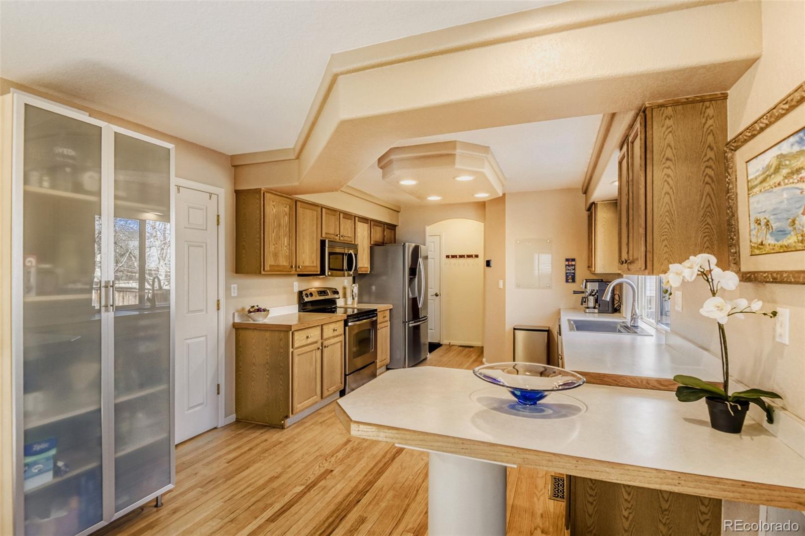 9649 Adelaide Circle Highlands Ranch, CO 80130 - Photo 7 of 32 a kitchen with a sink appliances and cabinets