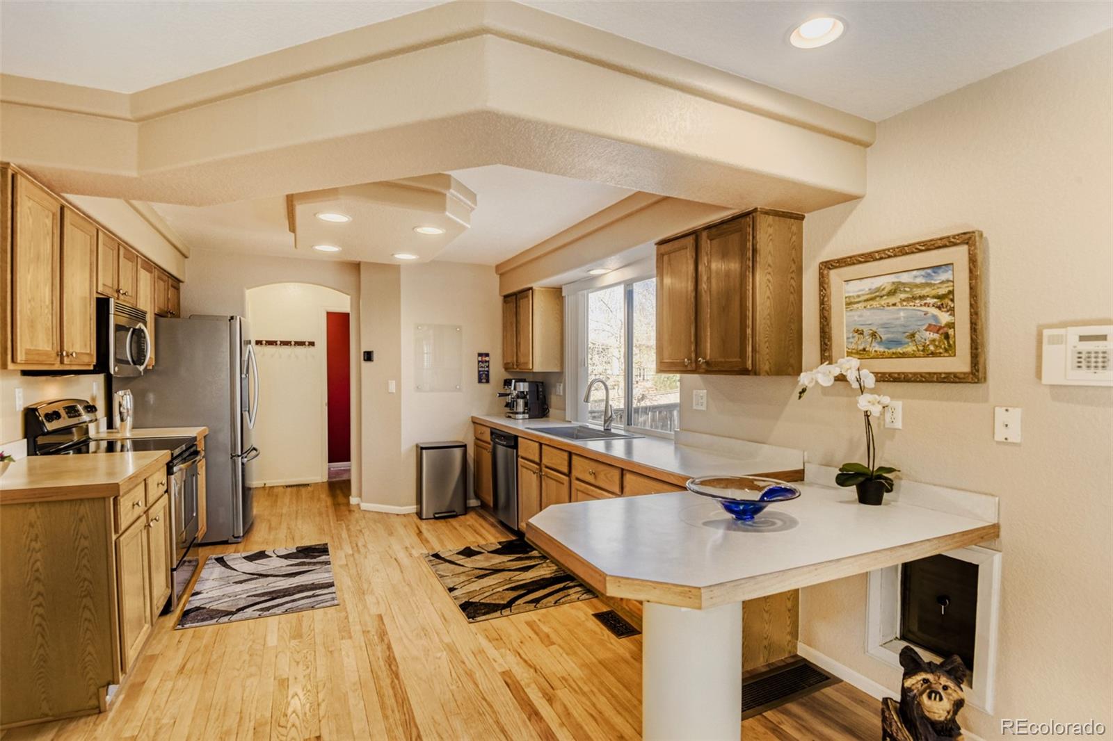 9649 Adelaide Circle Highlands Ranch, CO 80130 - Photo 9 of 32 a kitchen with a sink appliances and cabinets