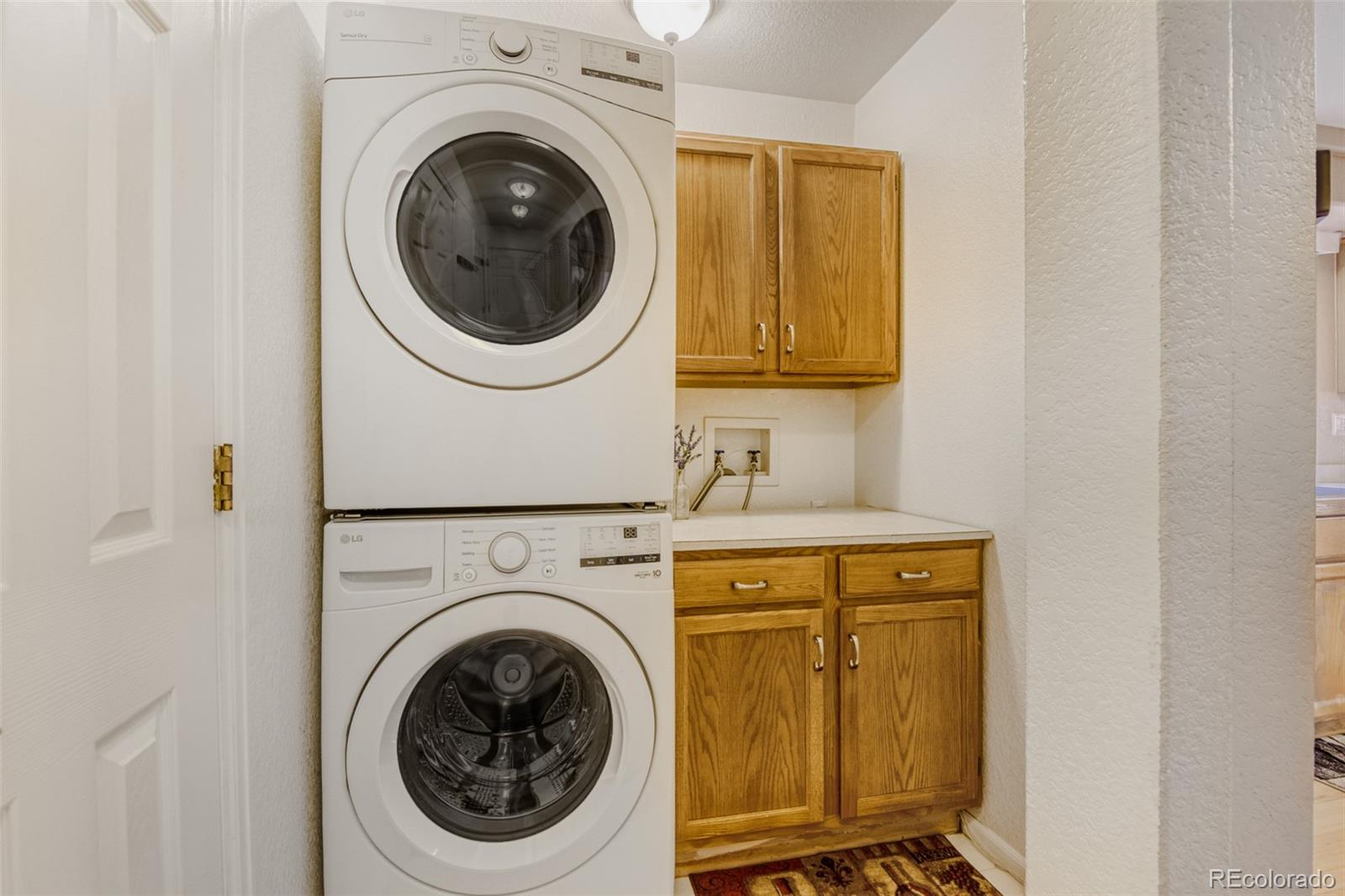9649 Adelaide Circle Highlands Ranch, CO 80130 - Photo 10 of 32 a utility room with dryer and washer