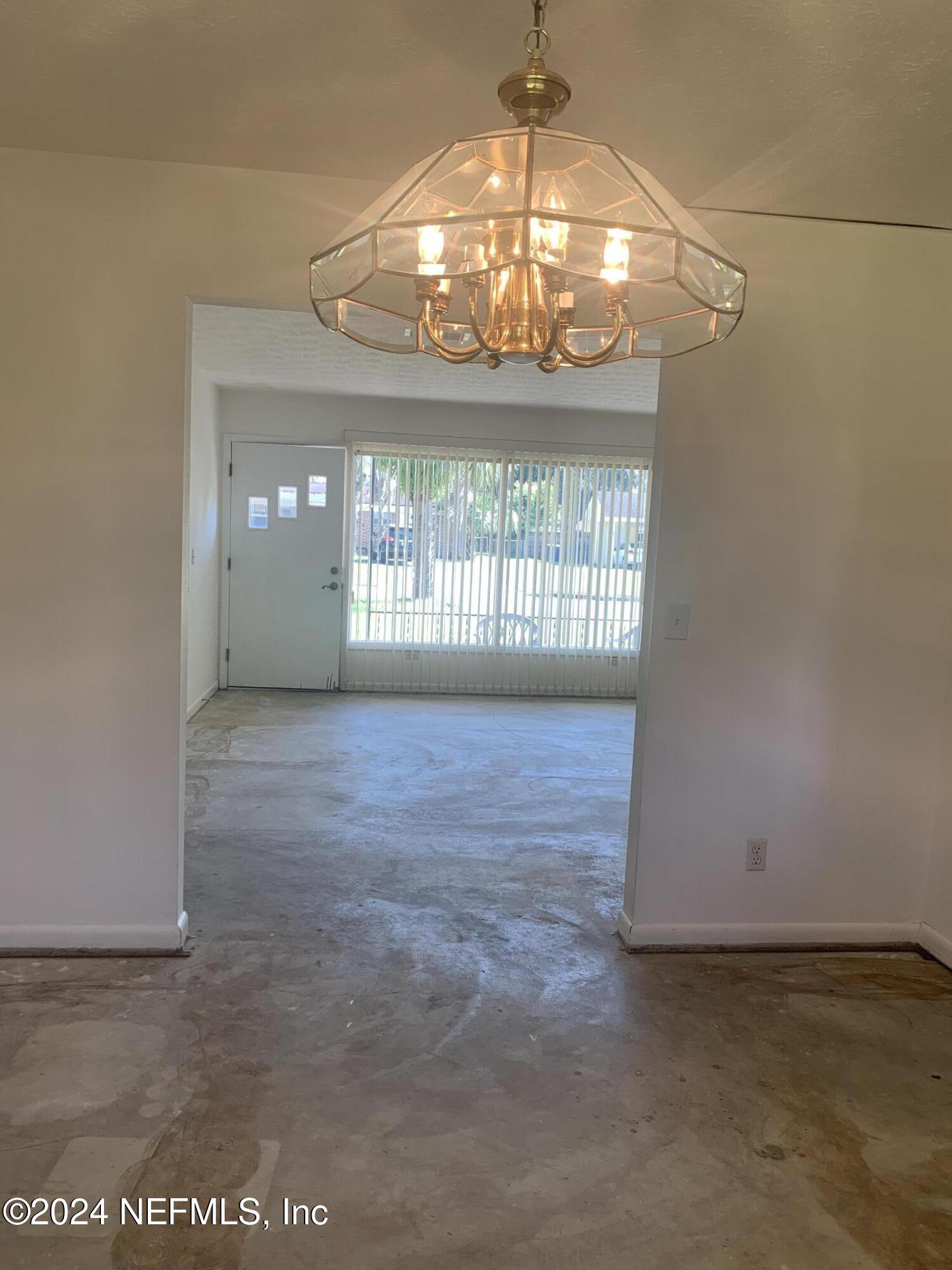 10558 Tulsa Road Jacksonville, FL 32218 - Photo 13 of 24 a view of an empty room with a chandelier