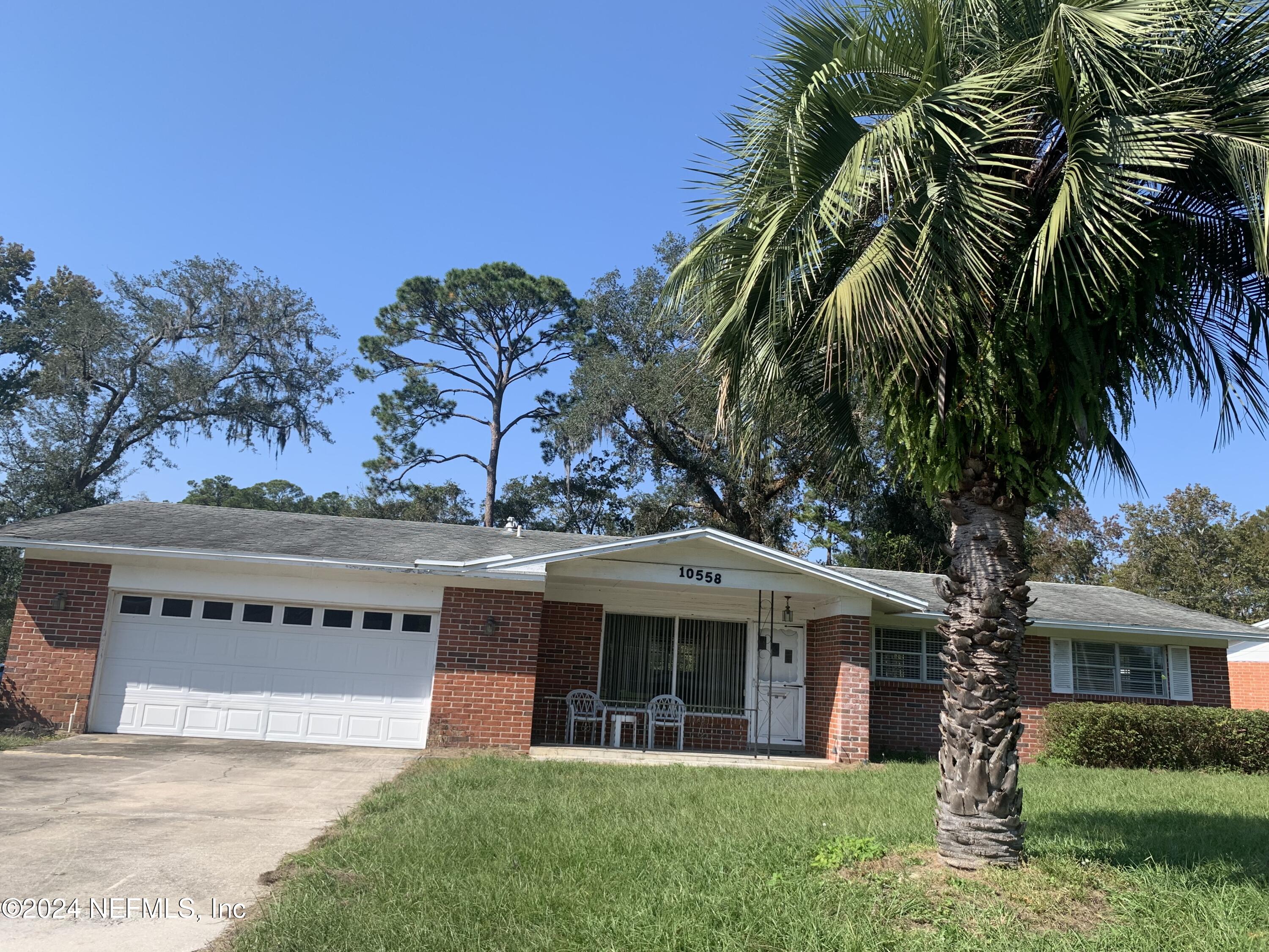 10558 Tulsa Road Jacksonville, FL 32218 - Photo 2 of 24 a front view of a house with a garden and a yard
