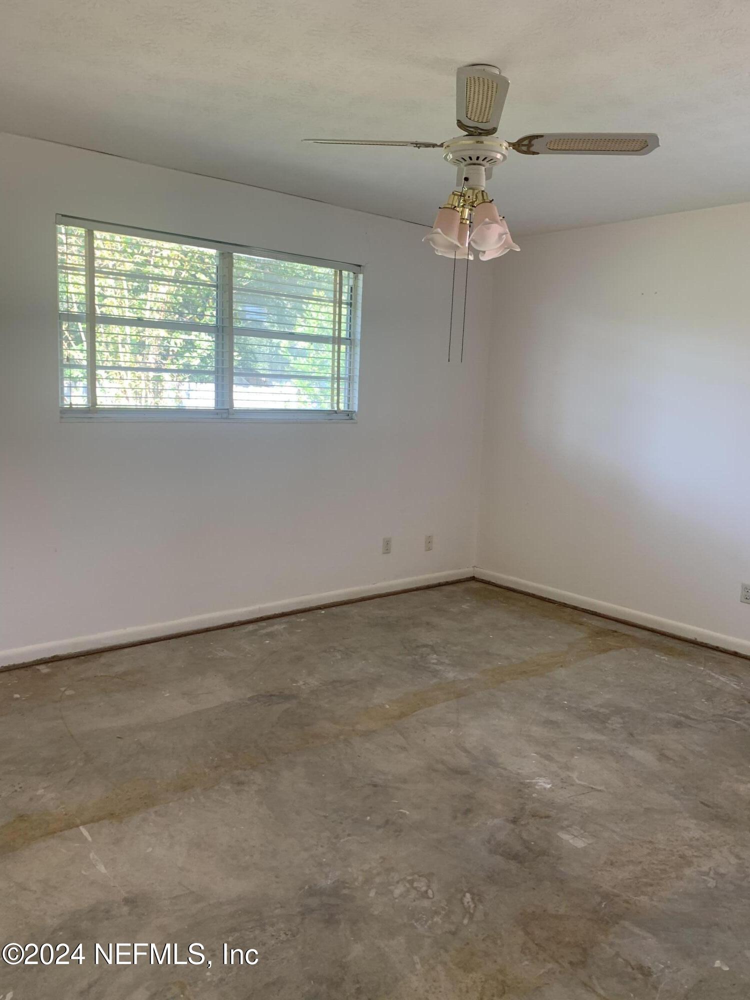 10558 Tulsa Road Jacksonville, FL 32218 - Photo 5 of 24 an empty room with a window