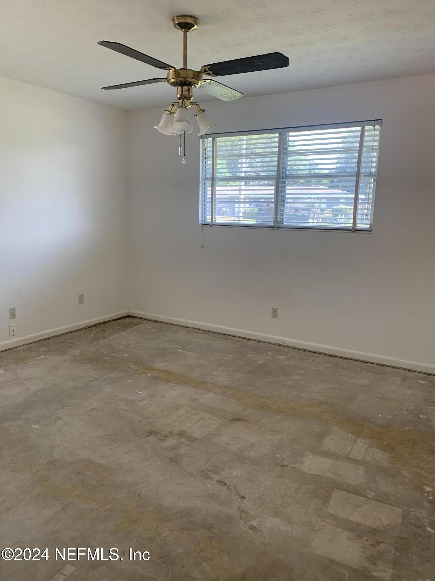 10558 Tulsa Road Jacksonville, FL 32218 - Photo 9 of 24 an empty room with a window