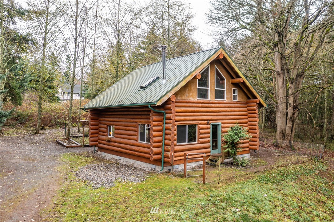 5720 Cameron Road Freeland, WA 98249 - Photo 1 of 36 a front view of a house with garden