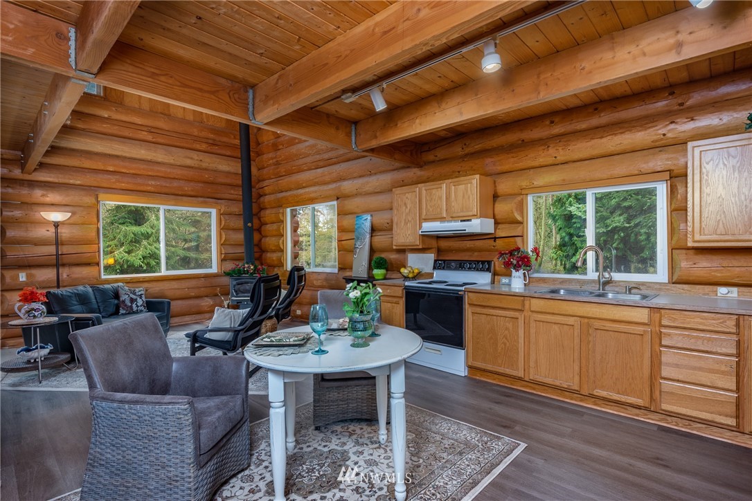 5720 Cameron Road Freeland, WA 98249 - Photo 11 of 36 a living room with furniture a window and kitchen view