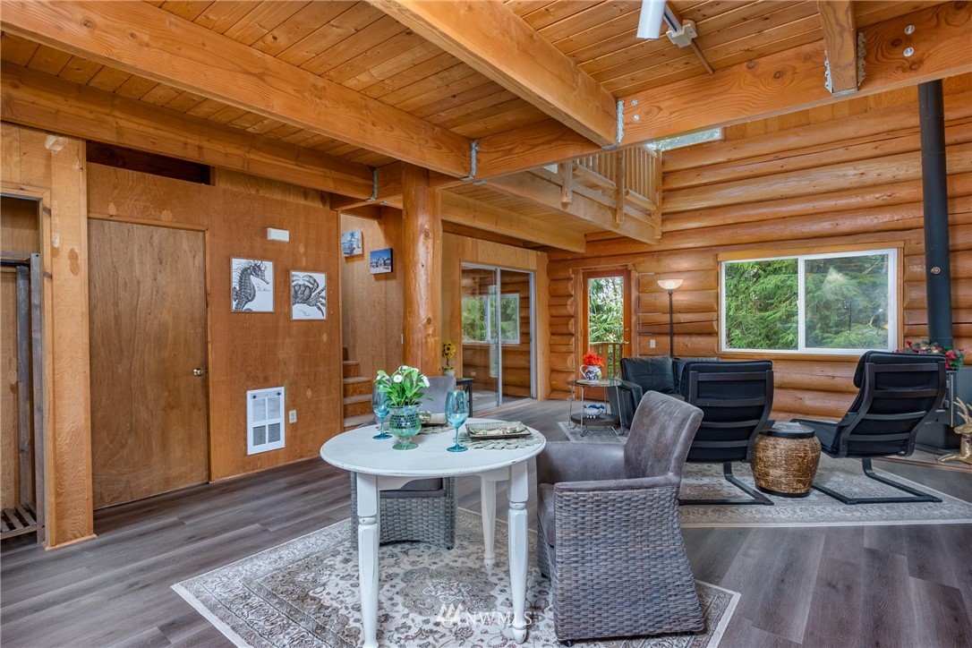 5720 Cameron Road Freeland, WA 98249 - Photo 13 of 36 a dining room with furniture a chandelier and wooden floor