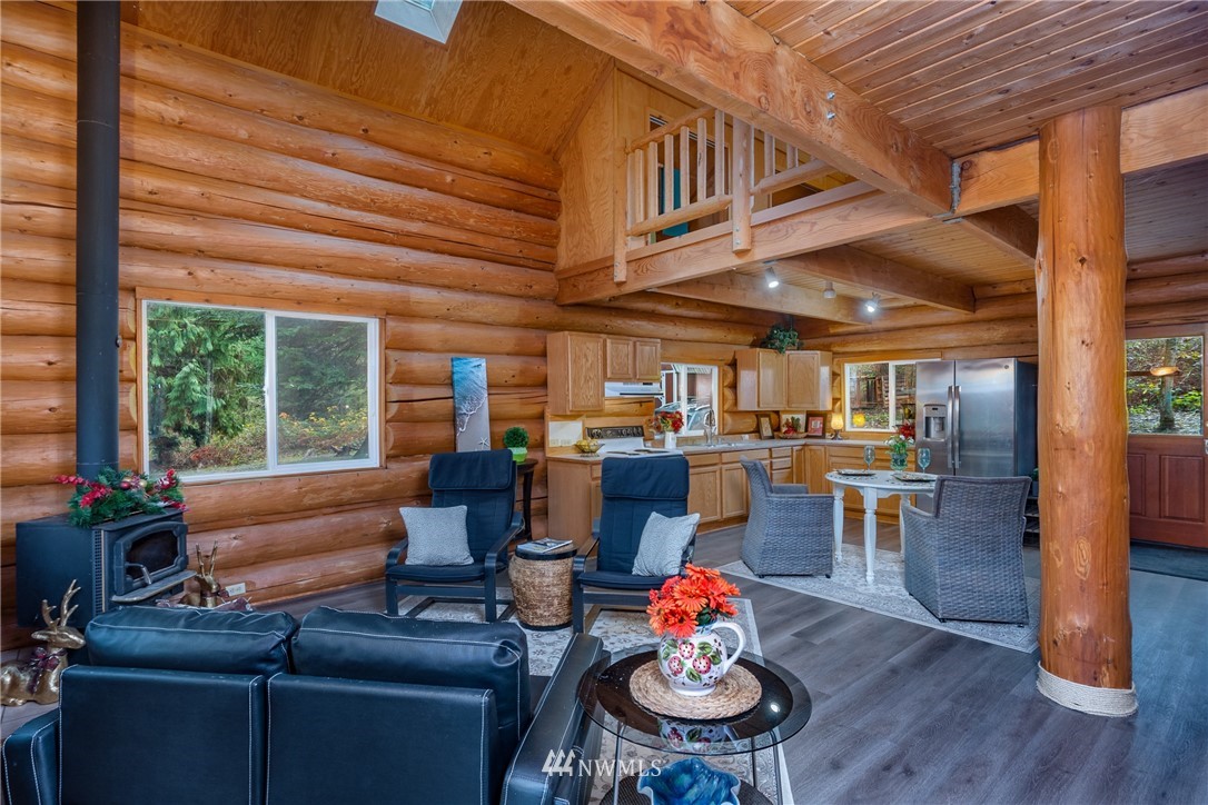 5720 Cameron Road Freeland, WA 98249 - Photo 18 of 36 a living room with furniture and a wooden floor