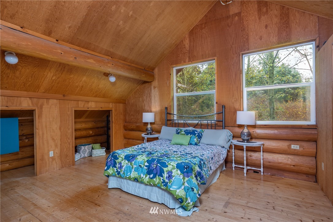 5720 Cameron Road Freeland, WA 98249 - Photo 24 of 36 a bedroom with a bed and a large window