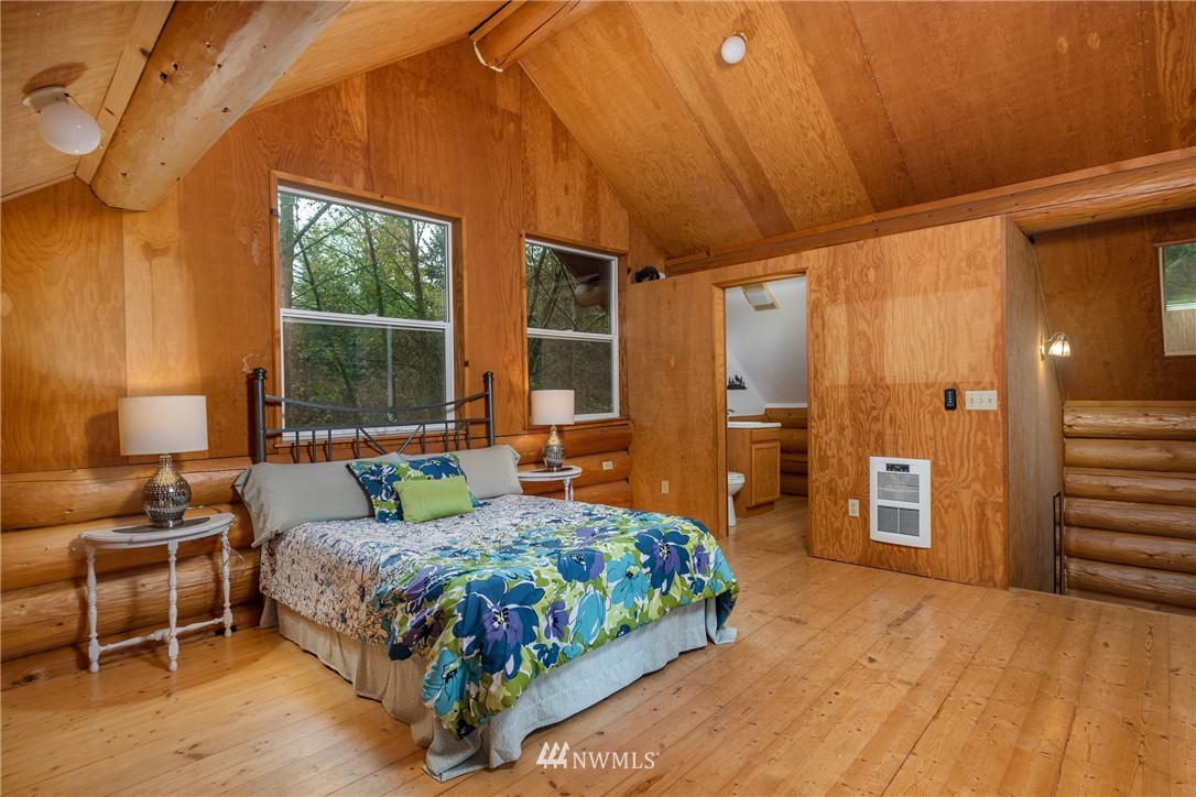 5720 Cameron Road Freeland, WA 98249 - Photo 25 of 36 a bedroom with a bed and a dresser next to a window