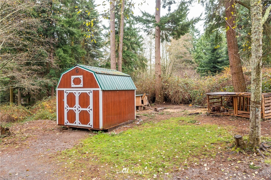 5720 Cameron Road Freeland, WA 98249 - Photo 32 of 36 a view of backyard with wooden fence and a bench