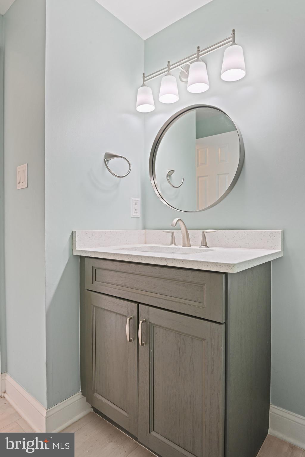 21174 Wildflower Square Ashburn, VA 20147 - Photo 16 of 30 a bathroom with a sink and a mirror