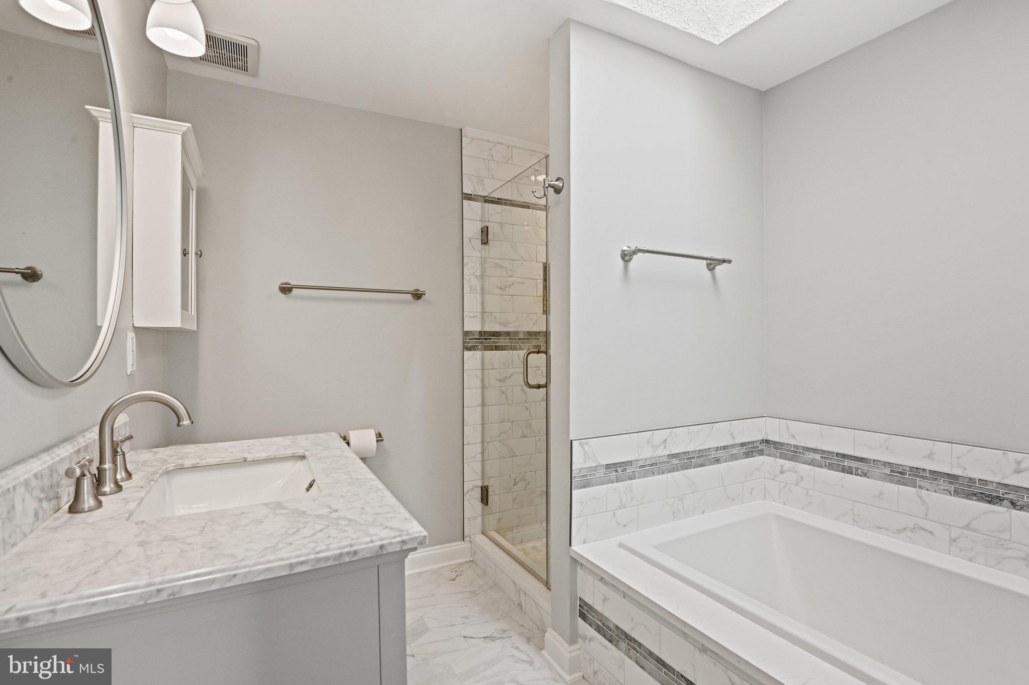 21174 Wildflower Square Ashburn, VA 20147 - Photo 17 of 30 a bathroom with a granite countertop sink and a bathtub