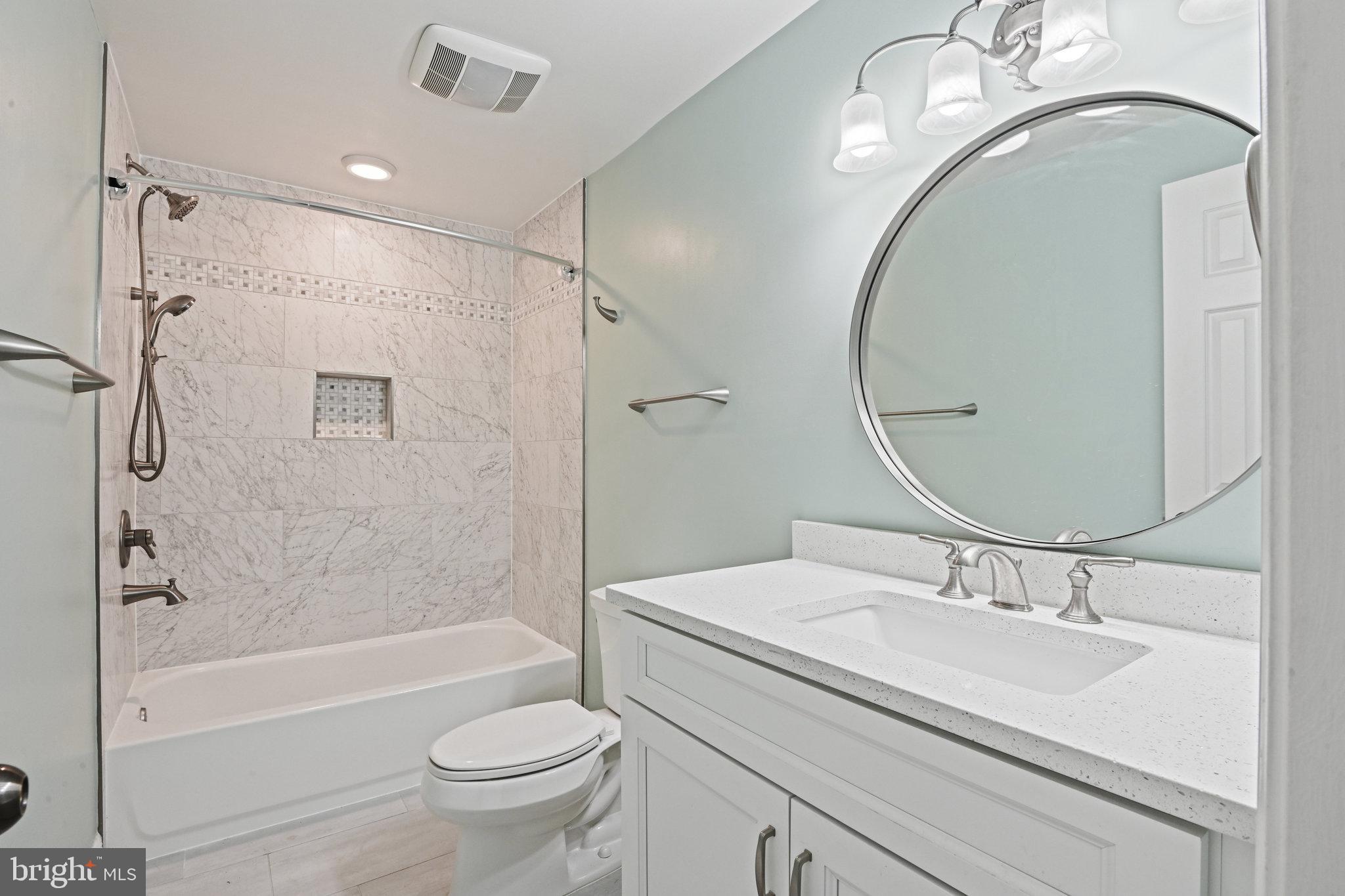 21174 Wildflower Square Ashburn, VA 20147 - Photo 20 of 30 a bathroom with a sink a toilet and a mirror