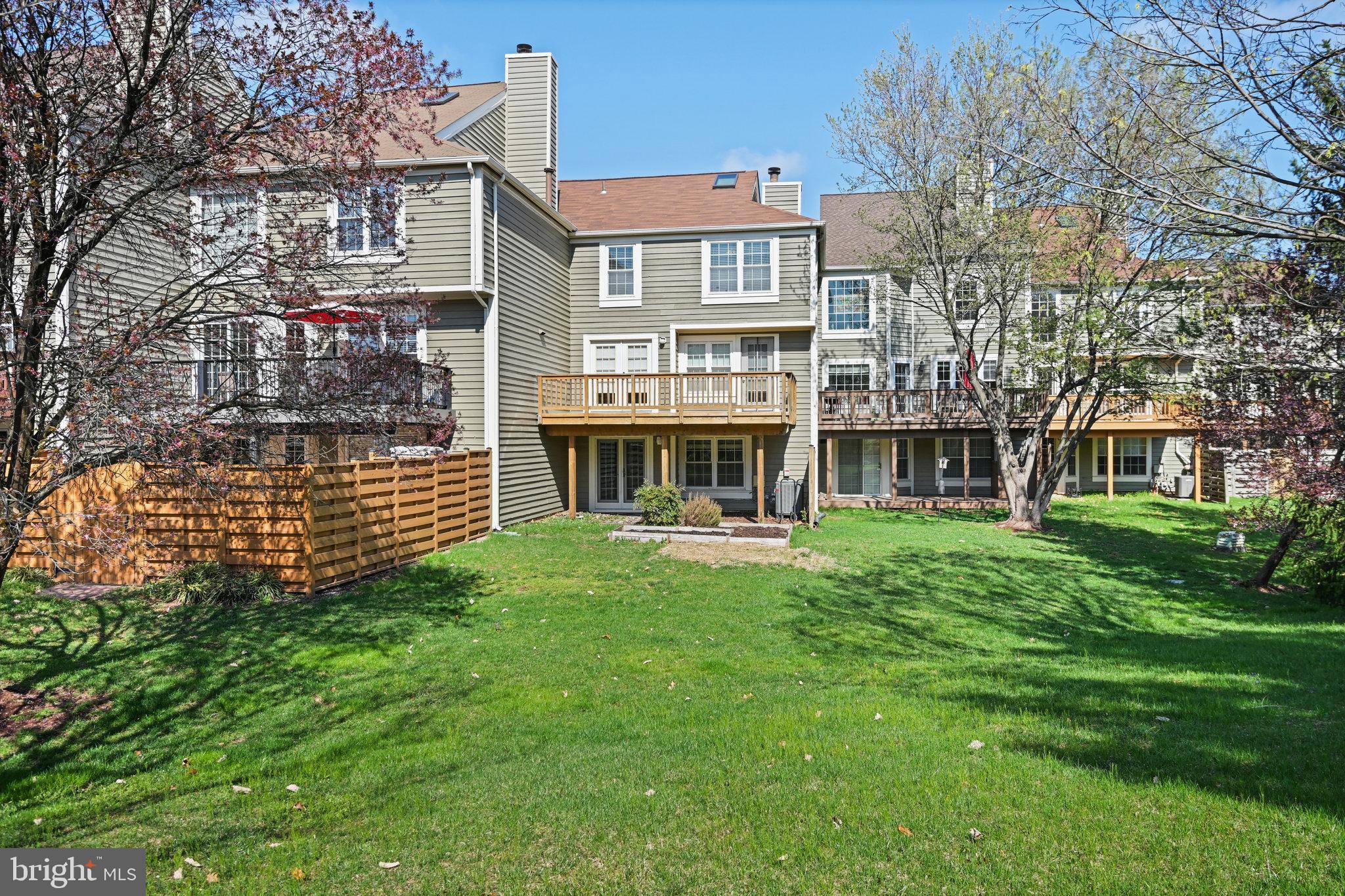 21174 Wildflower Square Ashburn, VA 20147 - Photo 2 of 30 a view of a house with a yard and sitting area