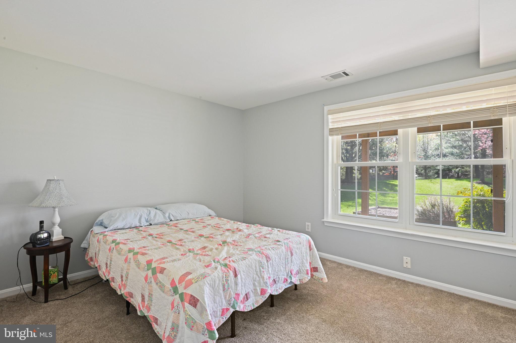 21174 Wildflower Square Ashburn, VA 20147 - Photo 23 of 30 a bedroom with a bed and a window