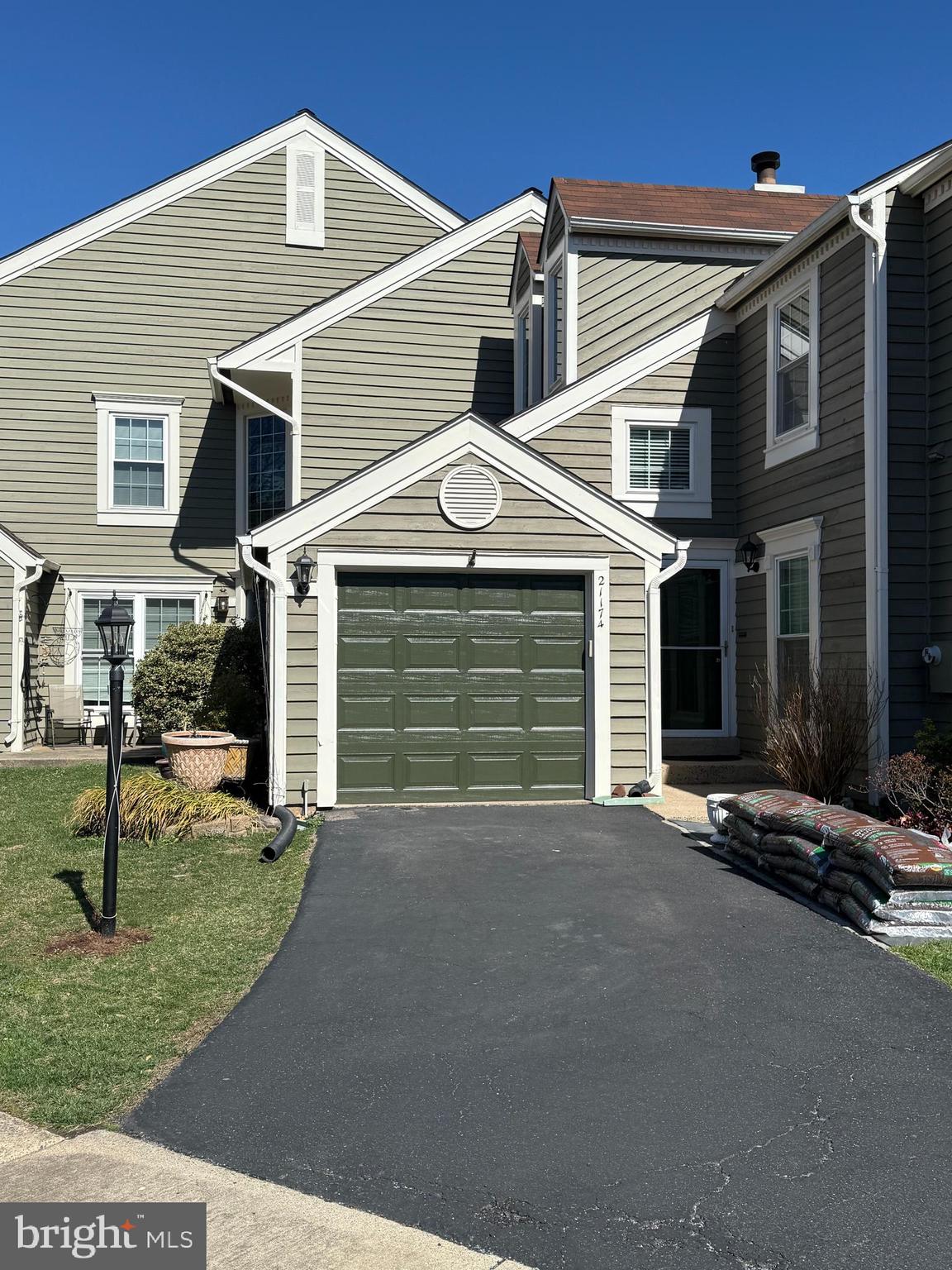 21174 Wildflower Square Ashburn, VA 20147 - Photo 3 of 30 a front view of a house with garden