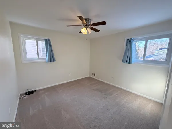 a view of a livingroom with a ceiling fan and window