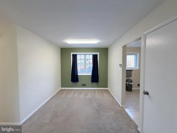 an empty room with windows and closet