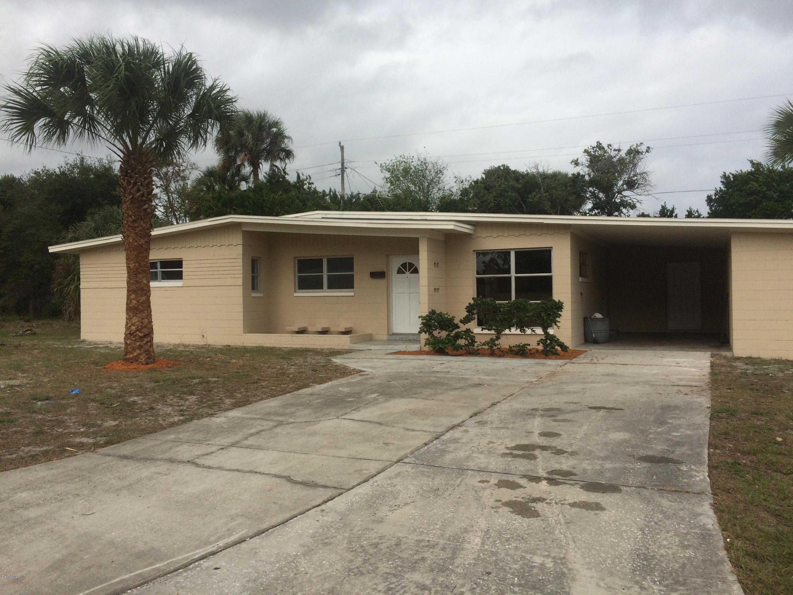 1040 Hickory Lane Cocoa, FL 32922 - Photo 2 of 17 a view of a house with backyard and a garage