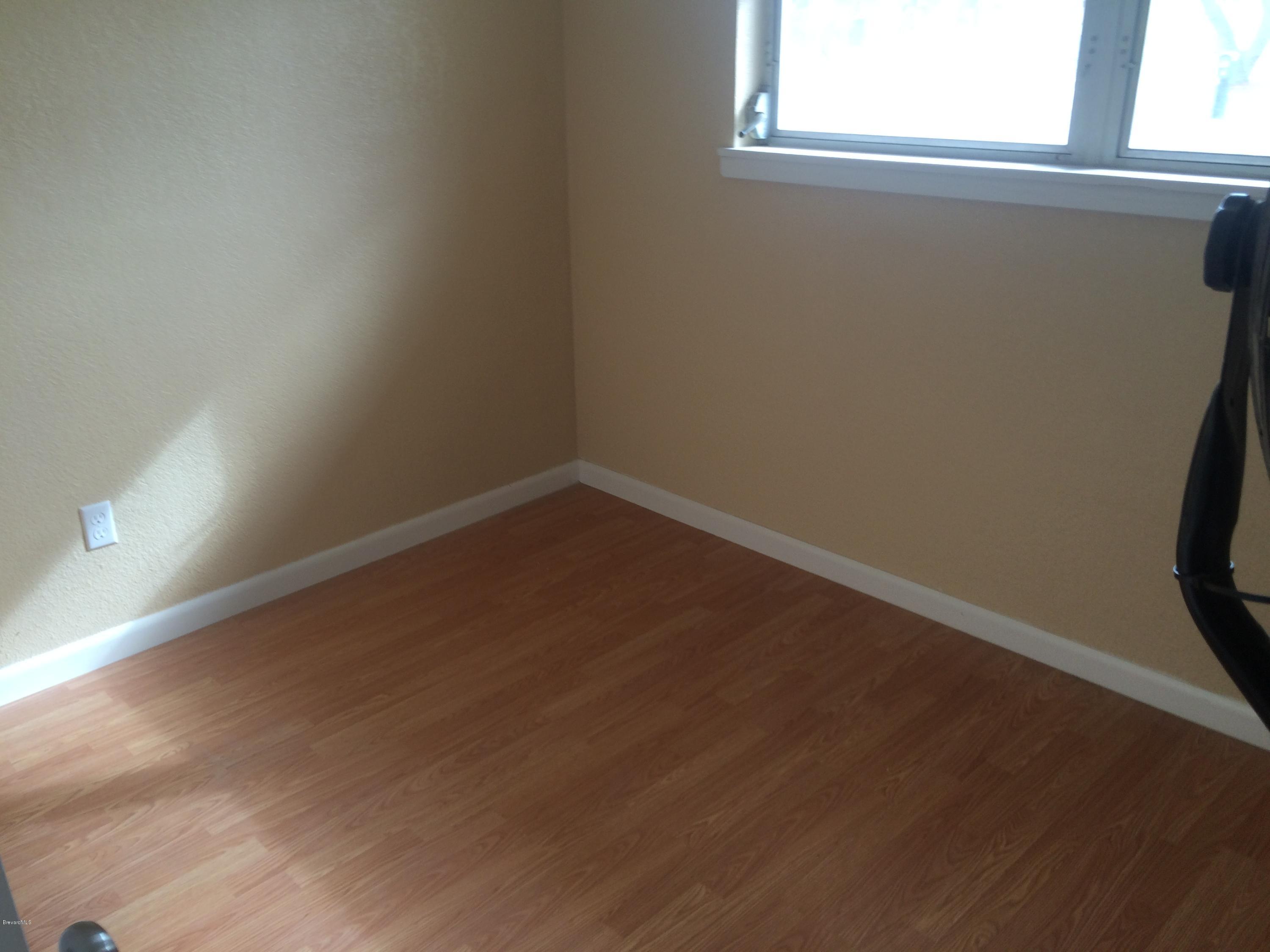 1040 Hickory Lane Cocoa, FL 32922 - Photo 11 of 17 a view of a small space with wooden floor and a window