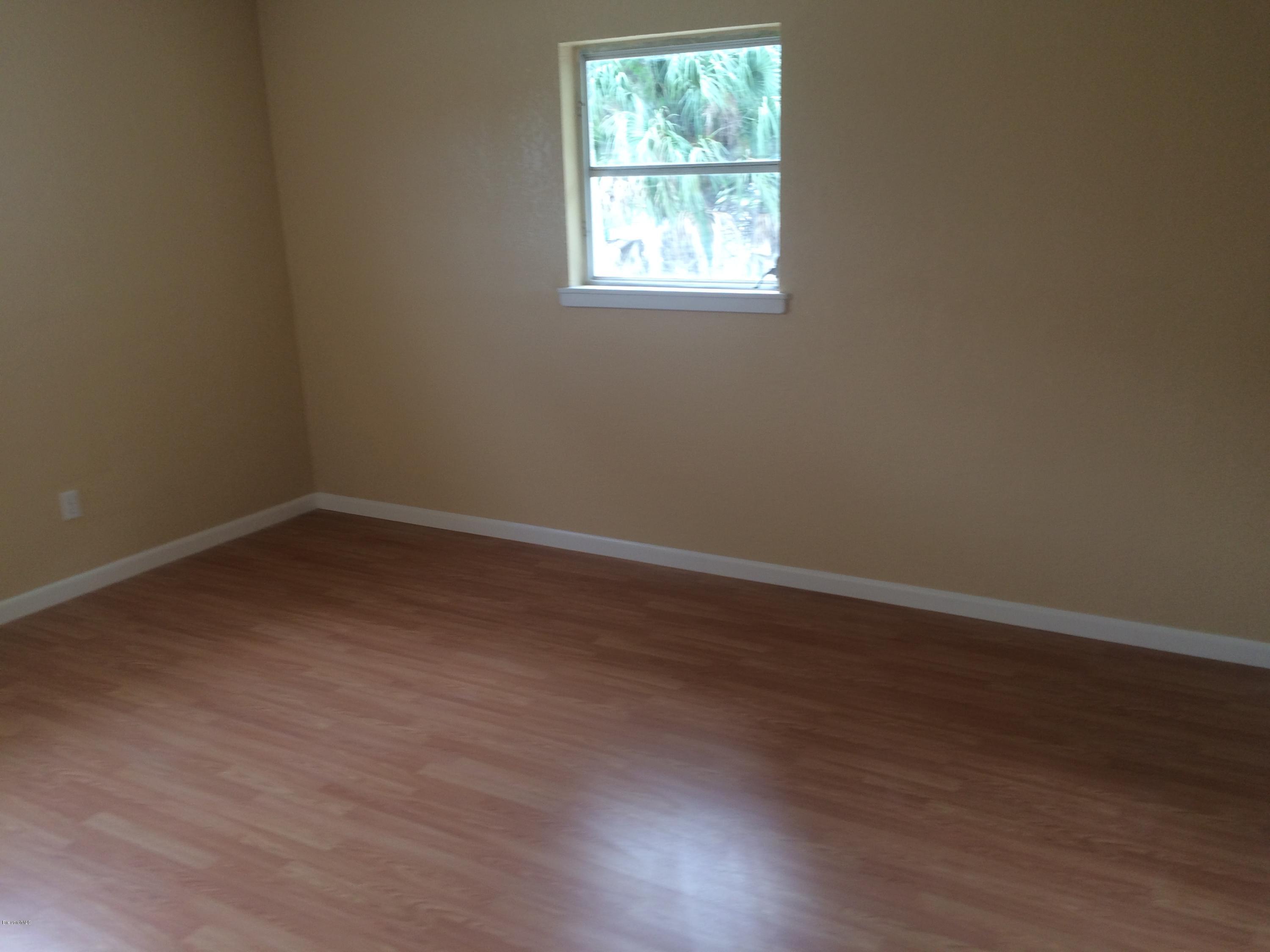 1040 Hickory Lane Cocoa, FL 32922 - Photo 12 of 17 an empty room with a window