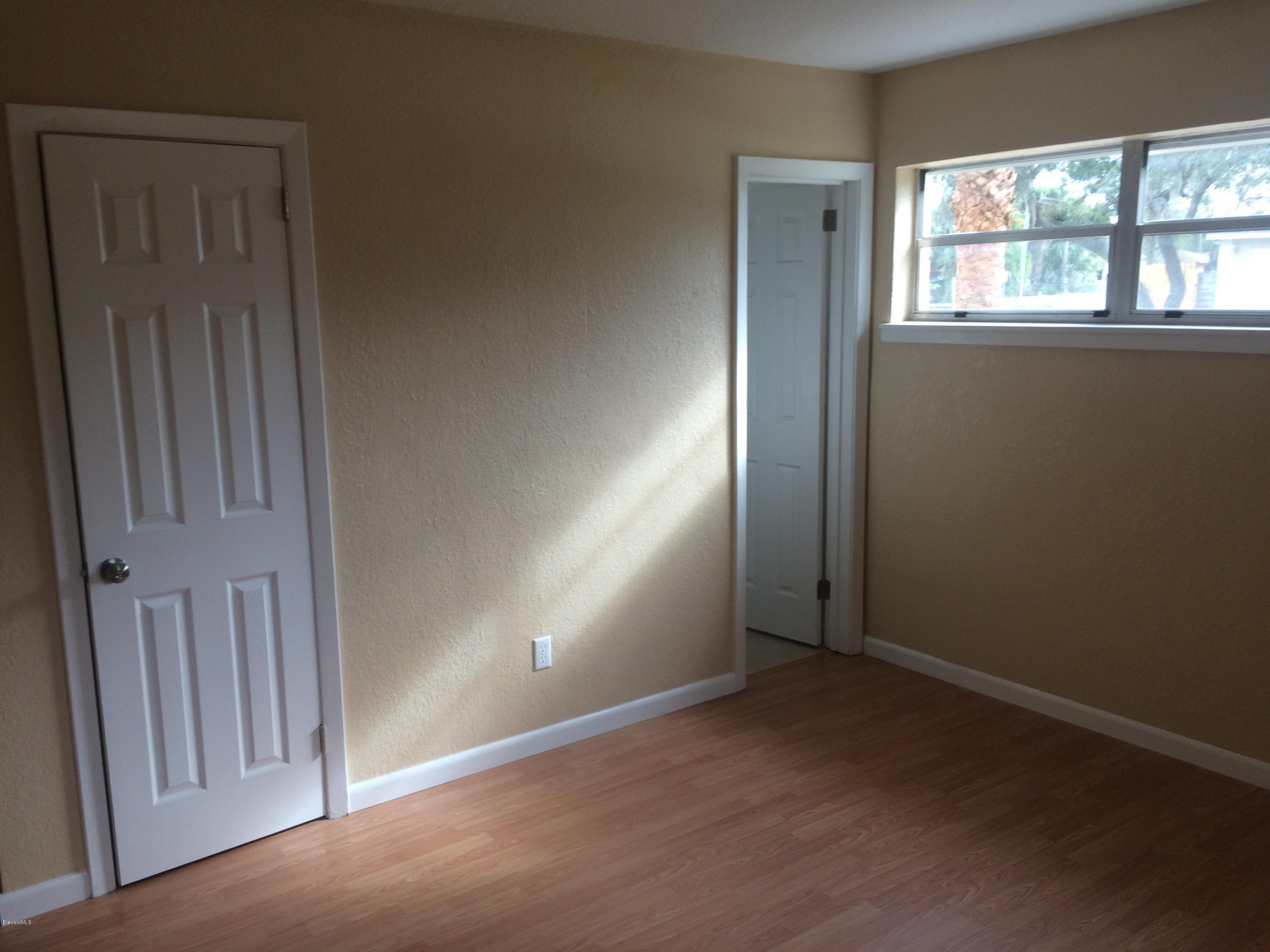 1040 Hickory Lane Cocoa, FL 32922 - Photo 13 of 17 an empty room with windows