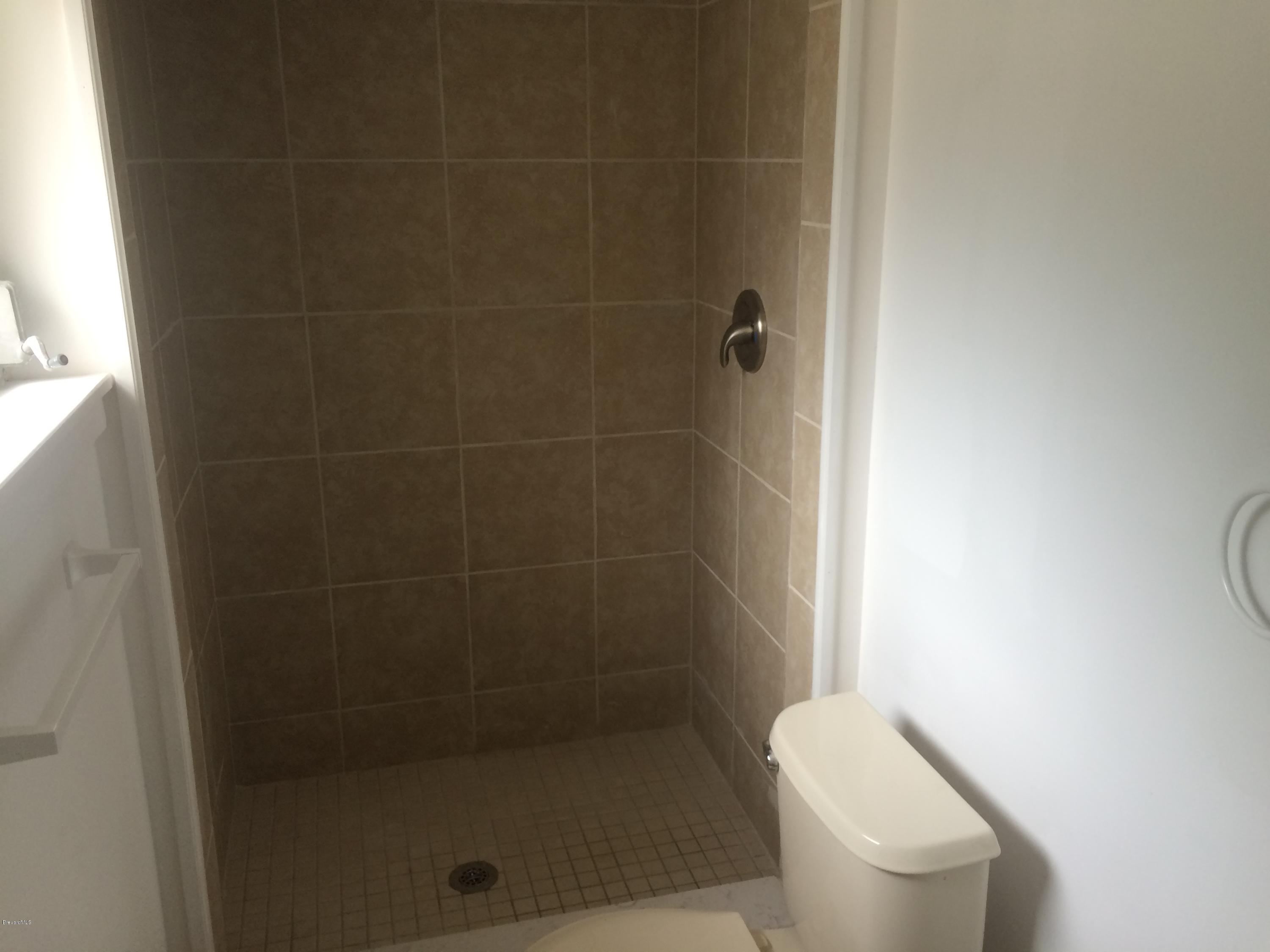 1040 Hickory Lane Cocoa, FL 32922 - Photo 16 of 17 a white toilet sitting next to a shower