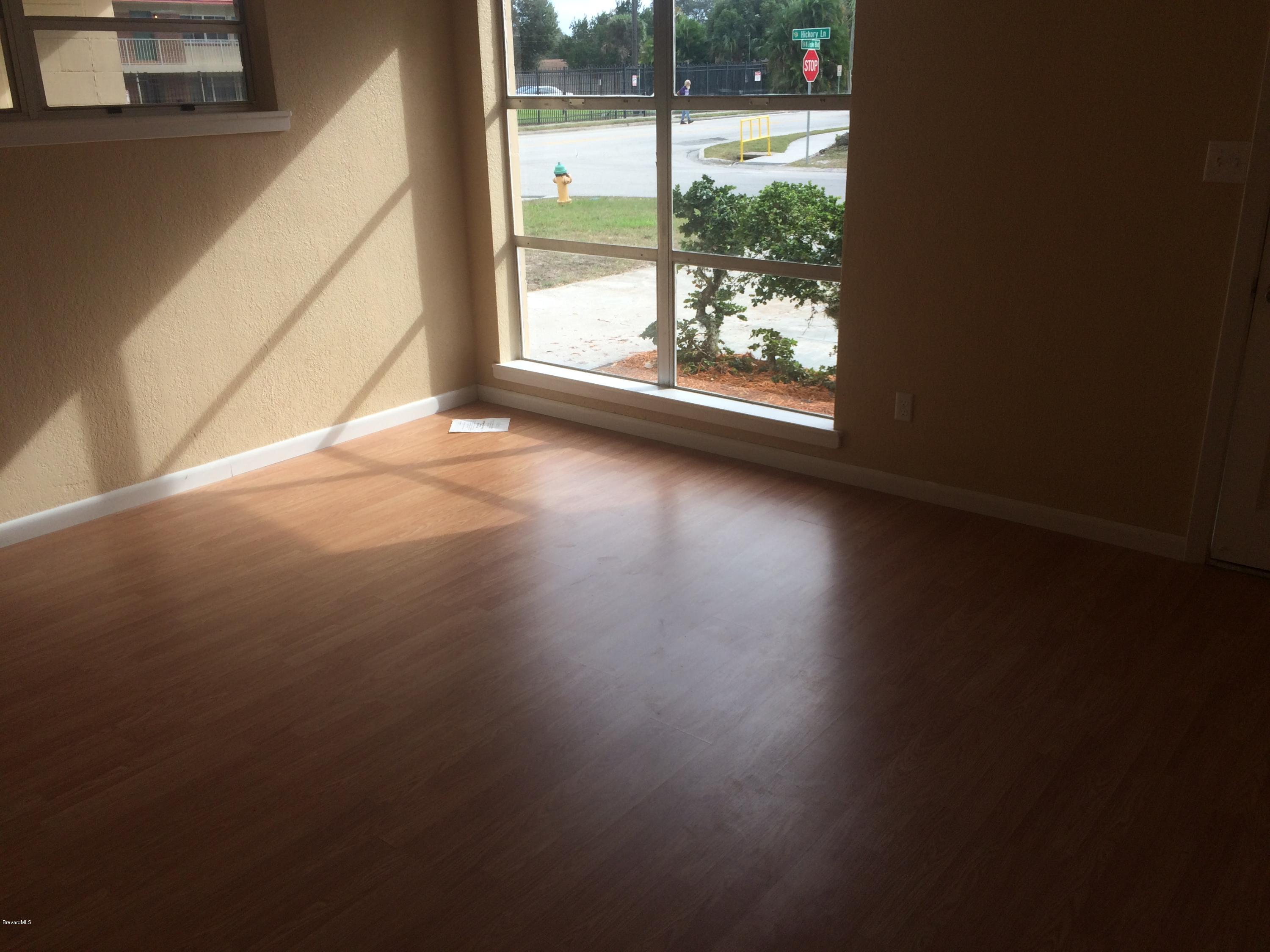 1040 Hickory Lane Cocoa, FL 32922 - Photo 6 of 17 a view of a livingroom with wooden floor and a window