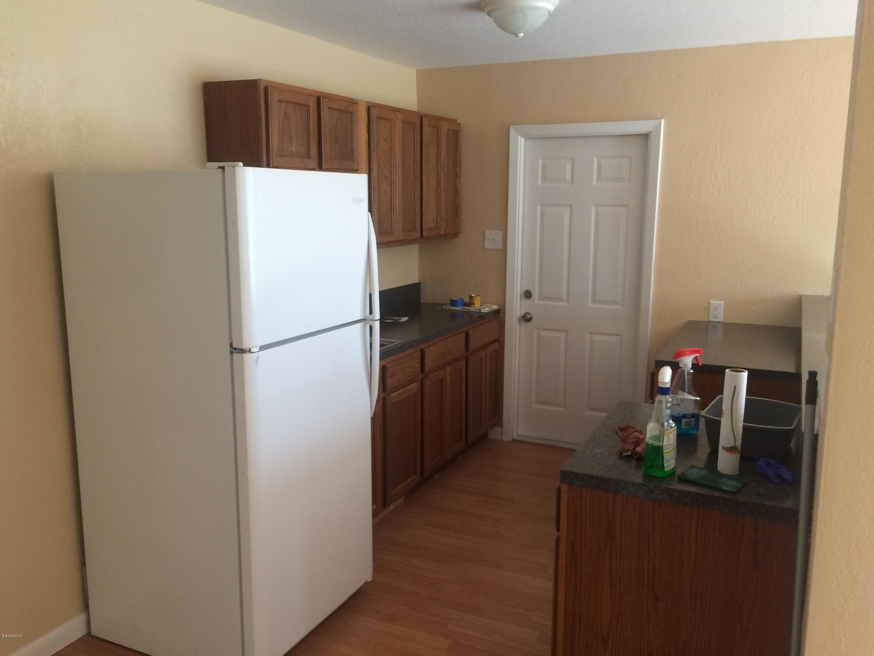 1040 Hickory Lane Cocoa, FL 32922 - Photo 8 of 17 a white refrigerator freezer sitting in a kitchen