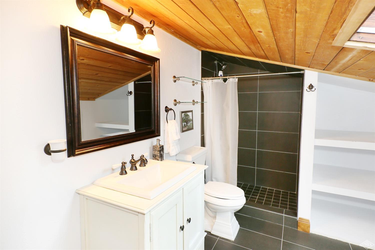 442 South Frontage Road East, Unit B306 Vail, CO 81657 - Photo 12 of 18 a bathroom with a sink toilet and shower