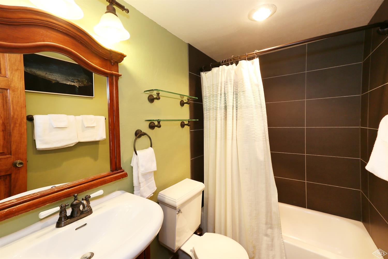 442 South Frontage Road East, Unit B306 Vail, CO 81657 - Photo 15 of 18 a bathroom with a sink mirror toilet and shower