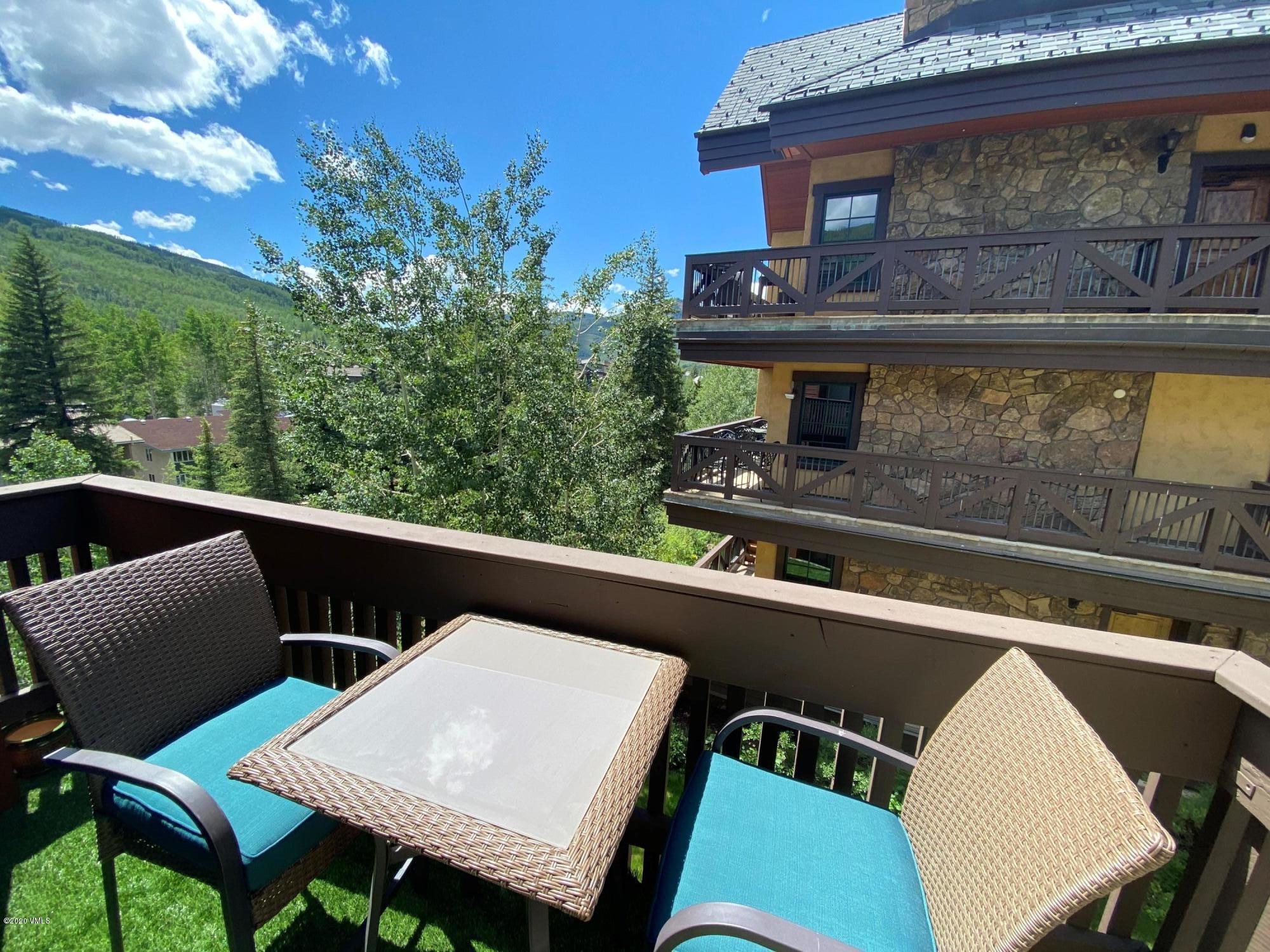 442 South Frontage Road East, Unit B306 Vail, CO 81657 - Photo 4 of 18 a view of a chair and tables in the balcony
