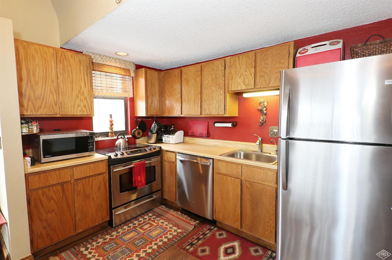 442 South Frontage Road East, Unit B306 Vail, CO 81657 - Photo 7 of 18 a kitchen with a sink stove and refrigerator