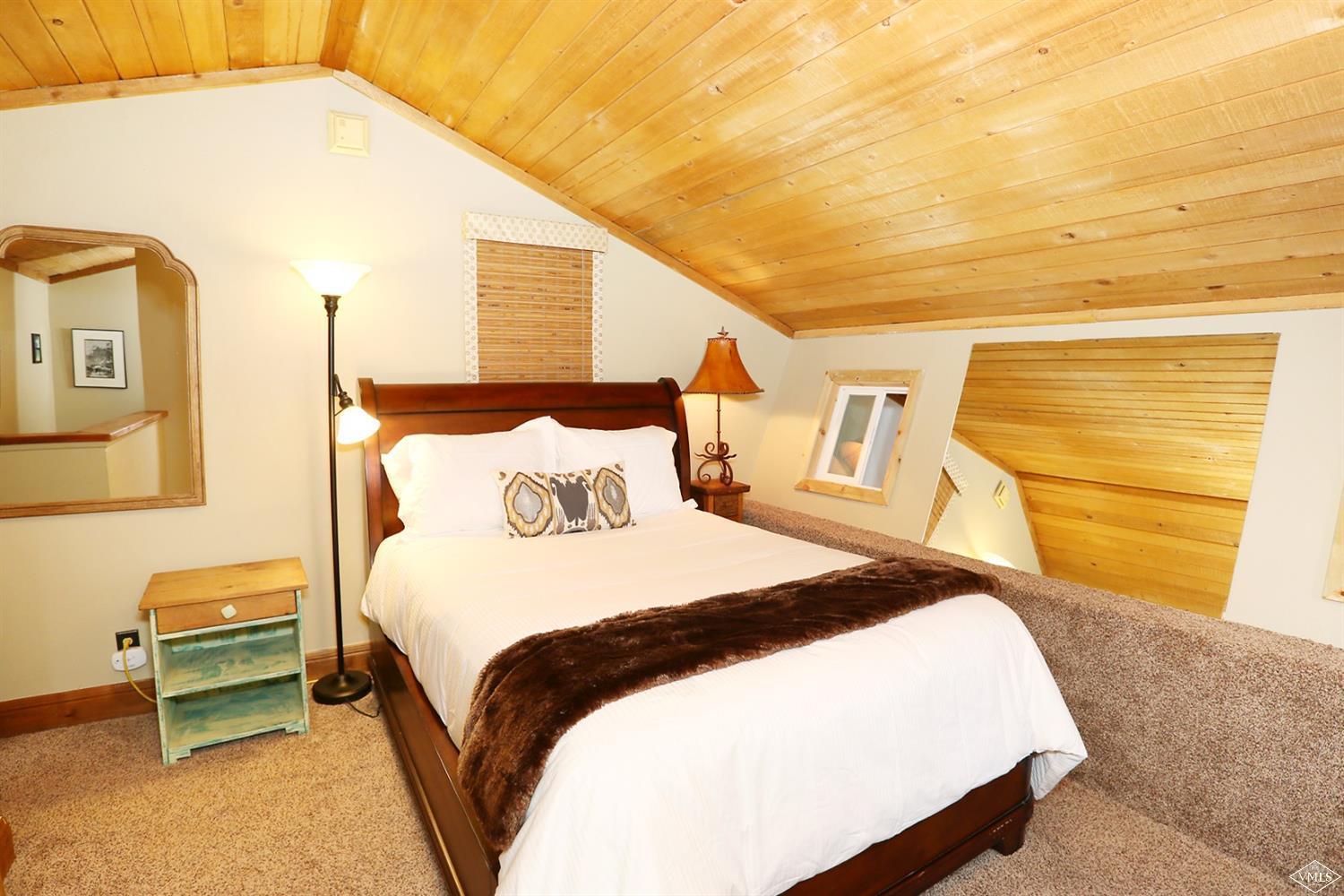 442 South Frontage Road East, Unit B306 Vail, CO 81657 - Photo 8 of 18 a bedroom with a bed and a night stand