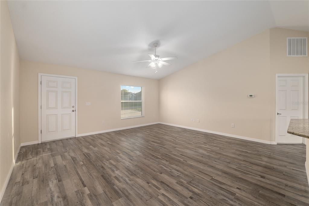 71 Juniper Trail Loop Ocala, FL 34480 - Photo 13 of 58 a view of an empty room with window and wooden floor