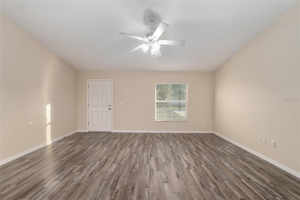 71 Juniper Trail Loop Ocala, FL 34480 - Photo 14 of 58 wooden floor in an empty room with a window