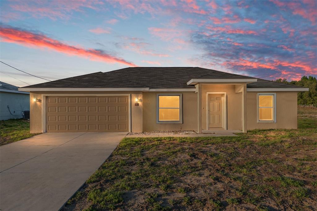 71 Juniper Trail Loop Ocala, FL 34480 - Photo 2 of 58 a front view of a house with garden