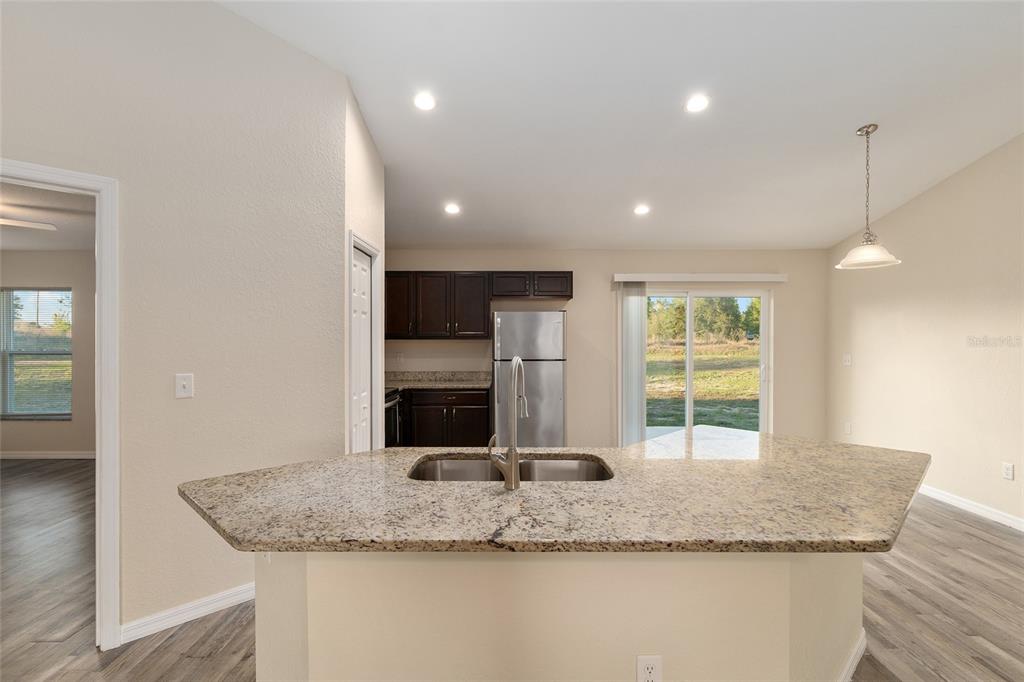 71 Juniper Trail Loop Ocala, FL 34480 - Photo 22 of 58 a bathroom with a granite countertop sink and a large mirror