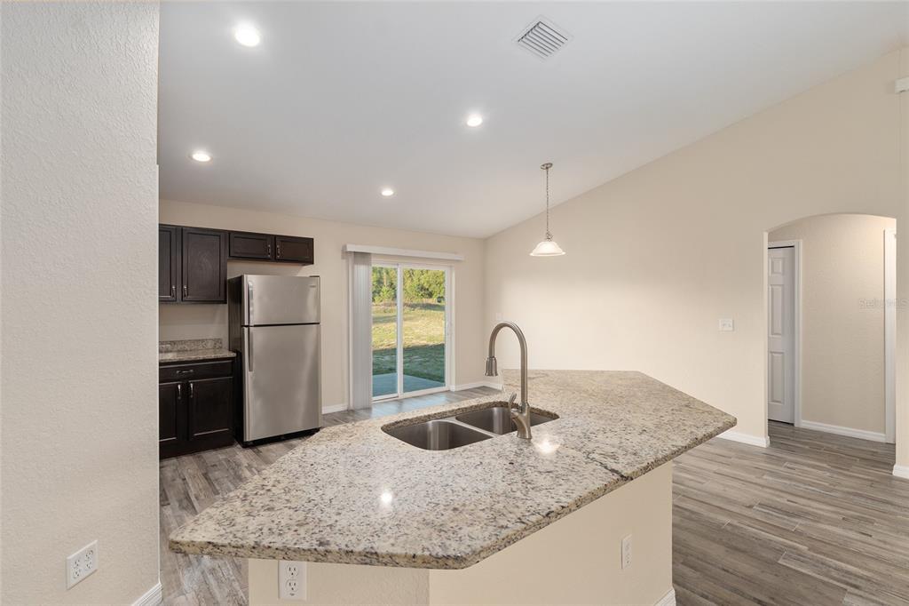 71 Juniper Trail Loop Ocala, FL 34480 - Photo 23 of 58 a kitchen with a refrigerator a sink and a stove