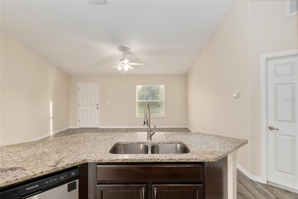 71 Juniper Trail Loop Ocala, FL 34480 - Photo 25 of 58 a kitchen with granite countertop a sink and a stove