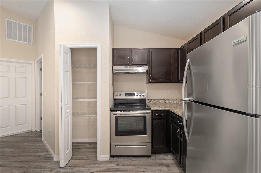 71 Juniper Trail Loop Ocala, FL 34480 - Photo 28 of 58 a kitchen with a stove and a refrigerator