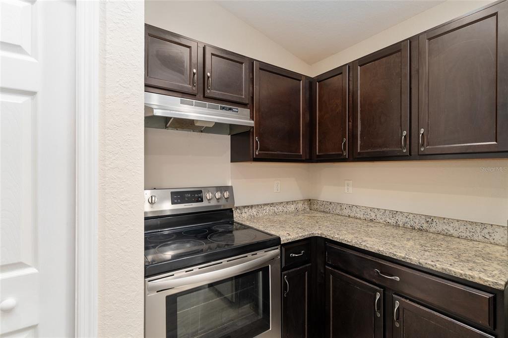 71 Juniper Trail Loop Ocala, FL 34480 - Photo 29 of 58 a kitchen with granite countertop cabinets and steel stainless steel appliances
