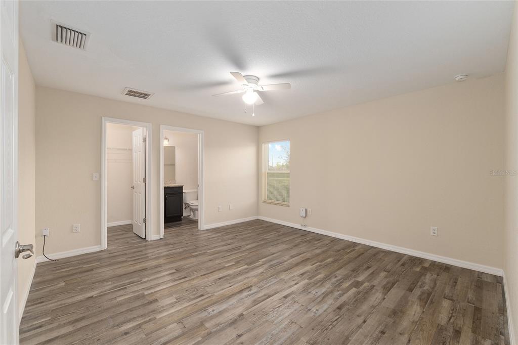 71 Juniper Trail Loop Ocala, FL 34480 - Photo 32 of 58 a view of an empty room with window and wooden floor