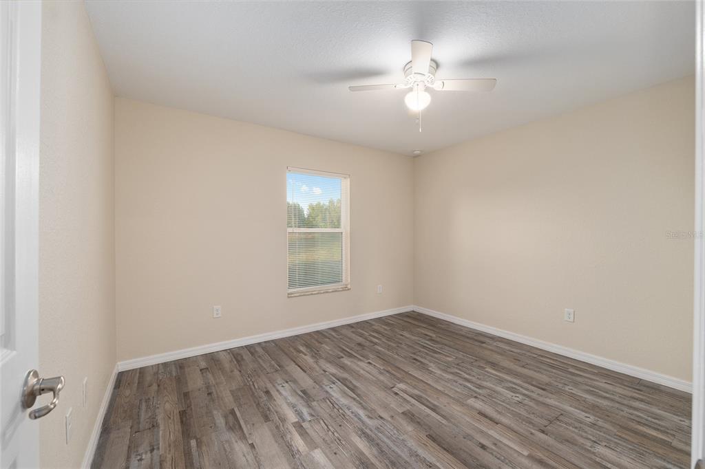 71 Juniper Trail Loop Ocala, FL 34480 - Photo 39 of 58 an empty room with wooden floor and windows