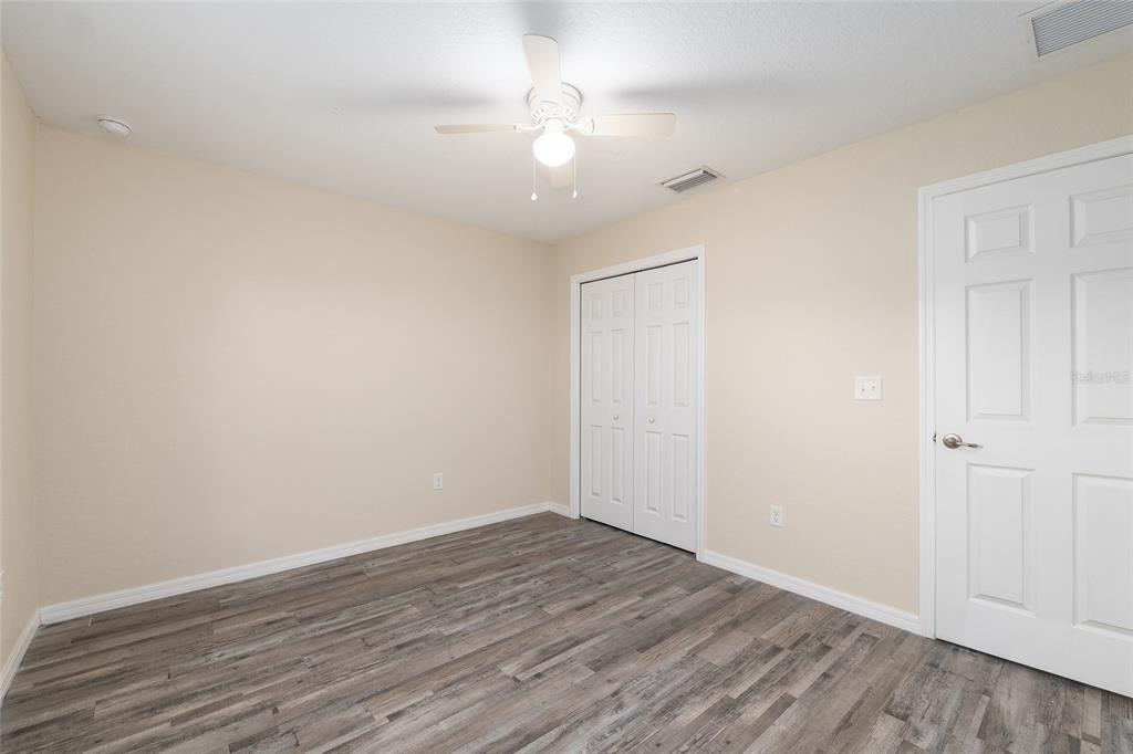 71 Juniper Trail Loop Ocala, FL 34480 - Photo 40 of 58 a view of an empty room with wooden floor