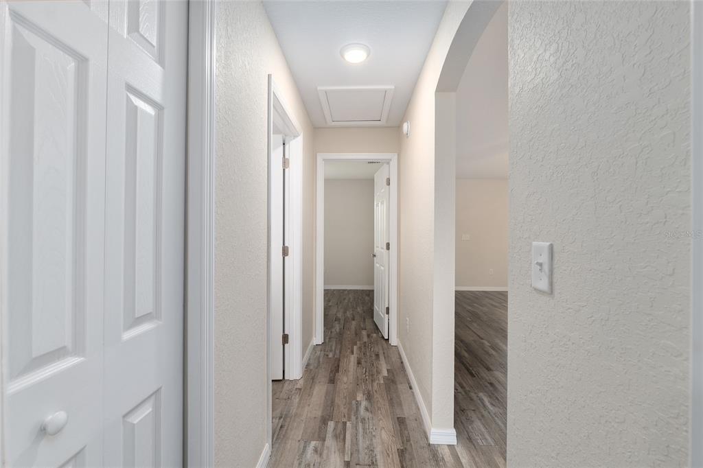 71 Juniper Trail Loop Ocala, FL 34480 - Photo 41 of 58 a view of a hallway with wooden floor