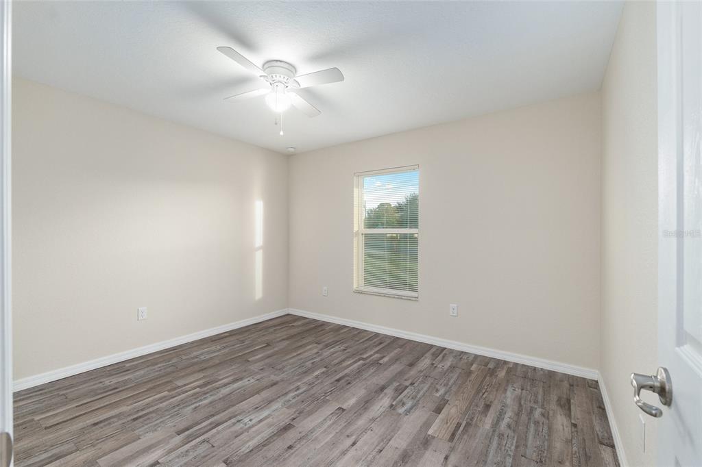 71 Juniper Trail Loop Ocala, FL 34480 - Photo 43 of 58 an empty room with wooden floor and windows