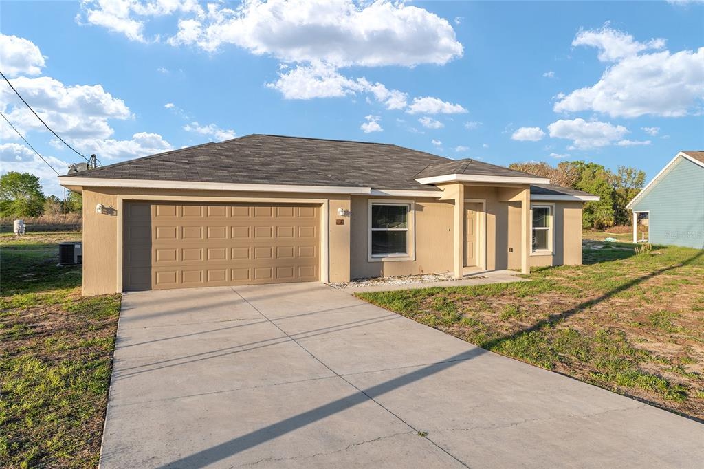 71 Juniper Trail Loop Ocala, FL 34480 - Photo 7 of 58 front view of a house with a pathway